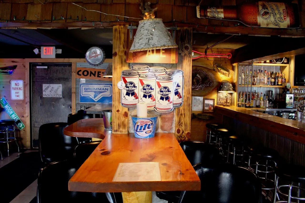 The warm wood interior of Gronk's with its bar signs and seating