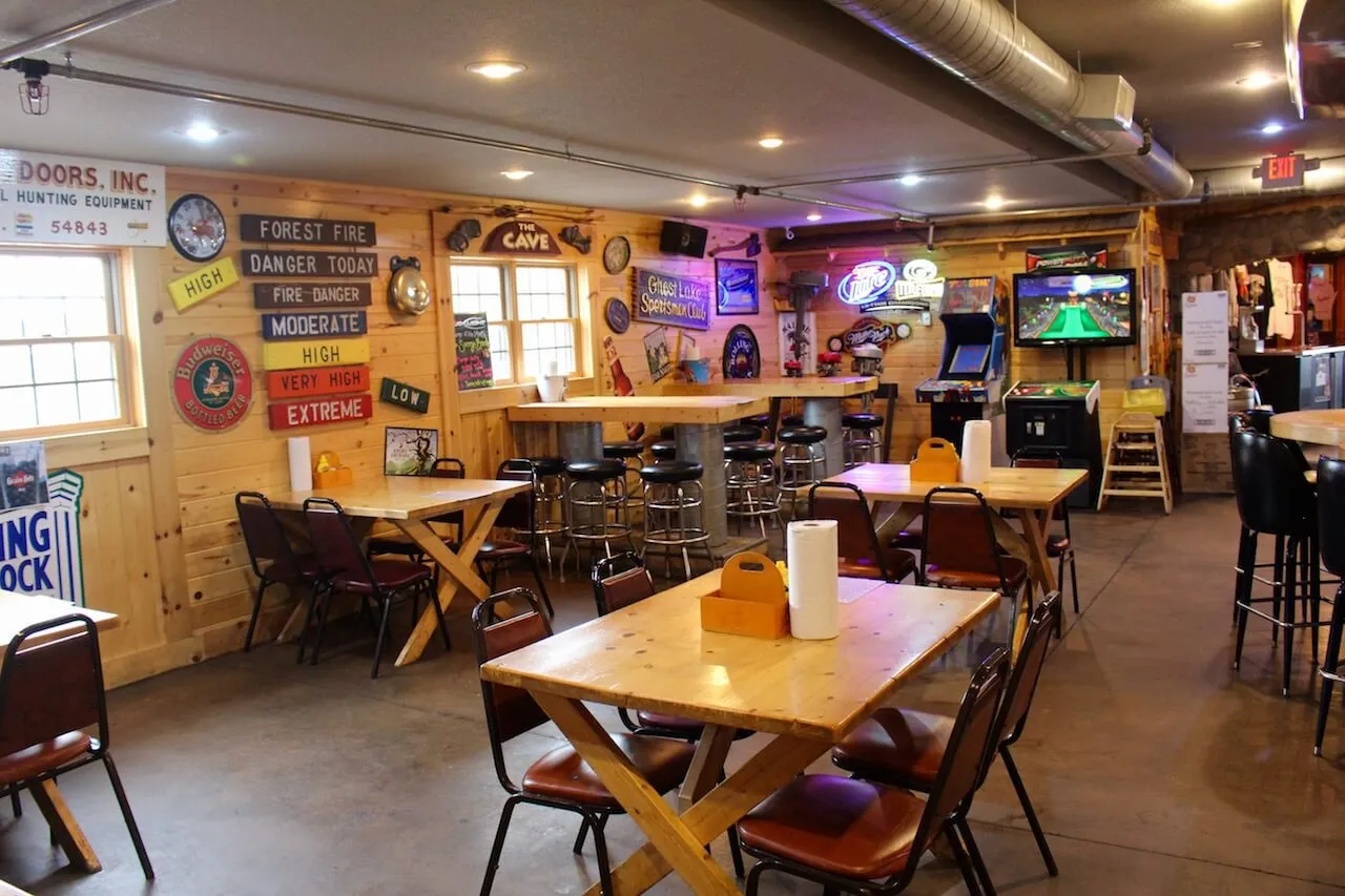 Wooden tables and chairs inside Gronk's Grill and Bar